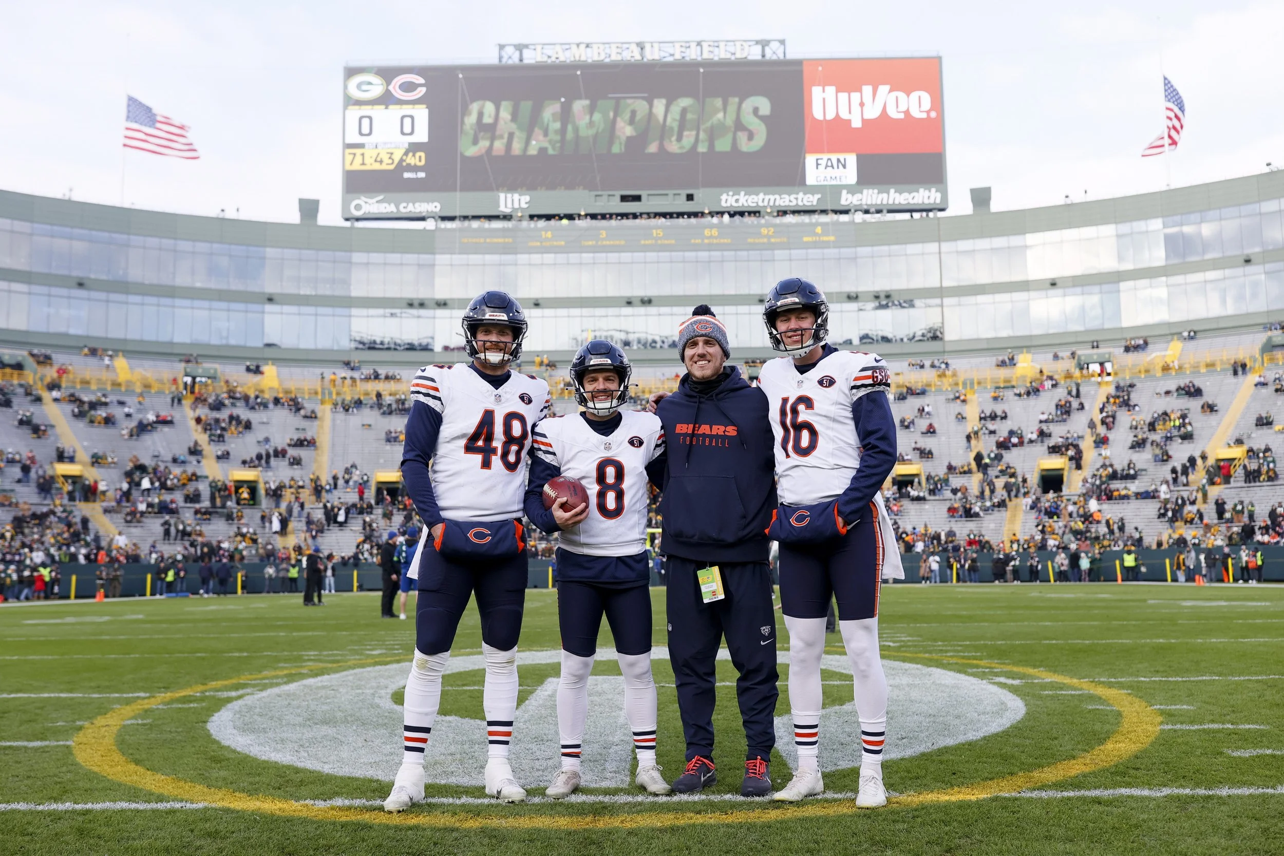 Trenton Gill with players on the football field